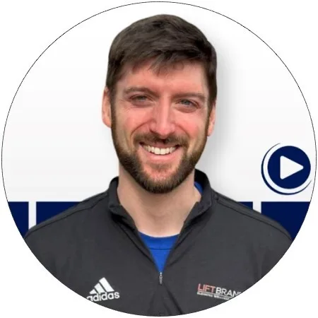 A man with short brown hair and a beard smiles at the camera. He is wearing a dark jacket with the Adidas logo and LIFT BRANDS text. The background is white with blue shapes and a play button icon.