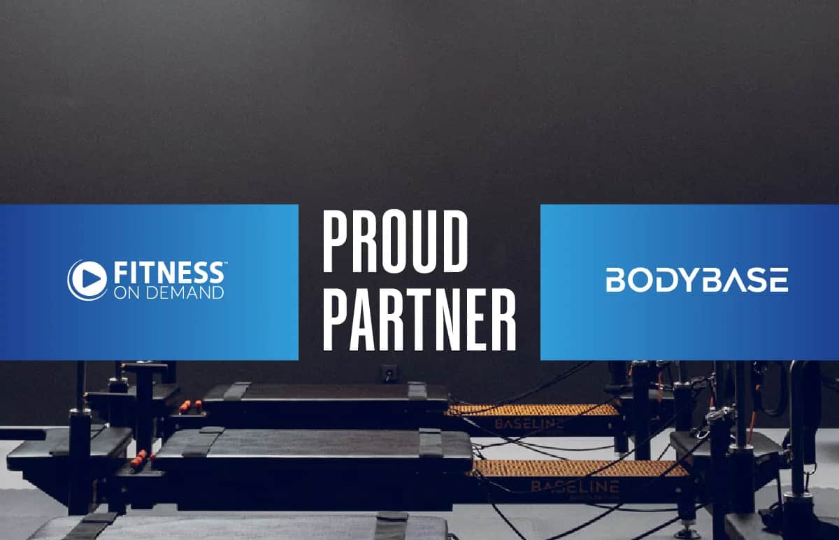 Fitness On Demand and BodyBase logos on a dark background with exercise equipment, separated by the text Proud Partner in bold white letters.