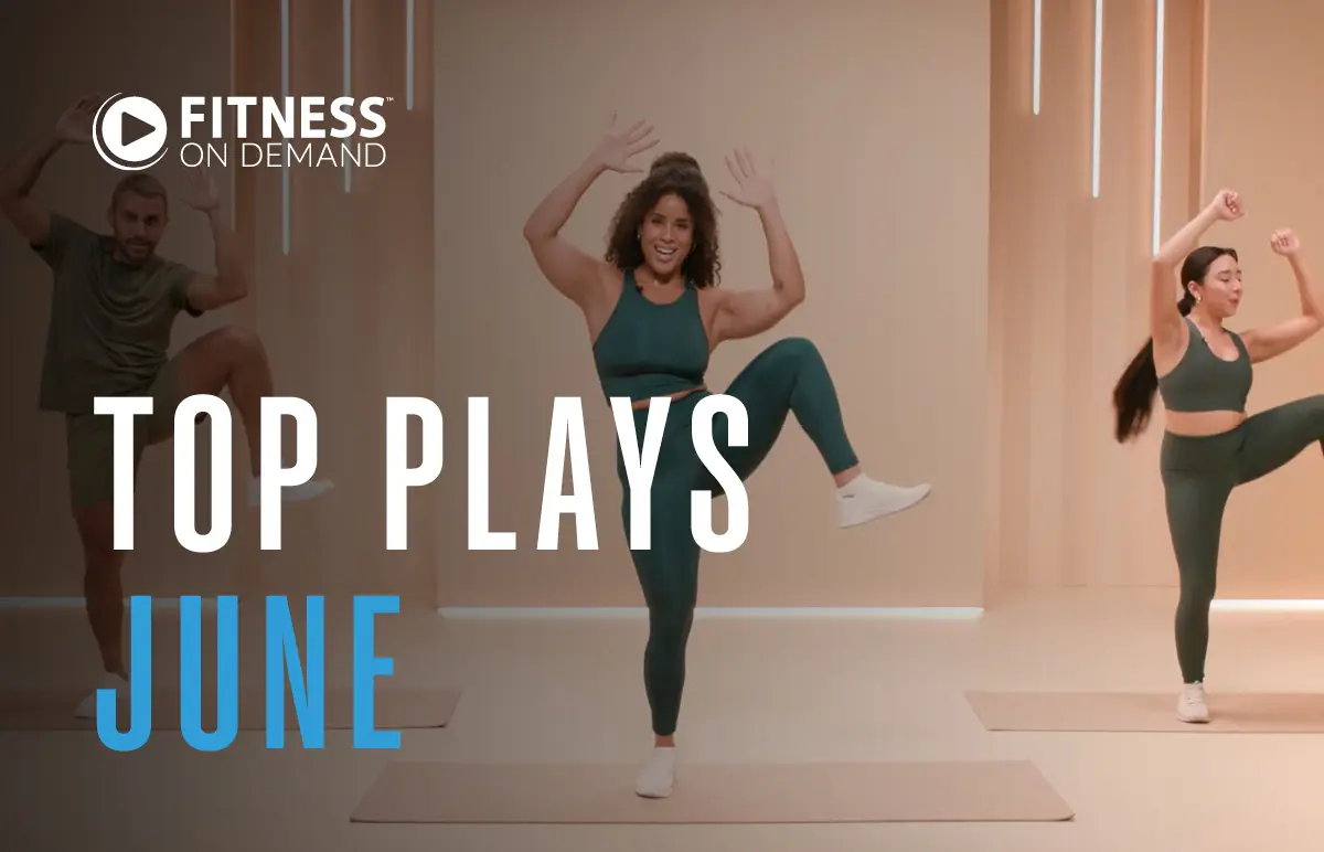 Three people in athletic wear perform energetic workout moves in a bright studio. Text reads “Fitness On Demand. Top Plays June.”