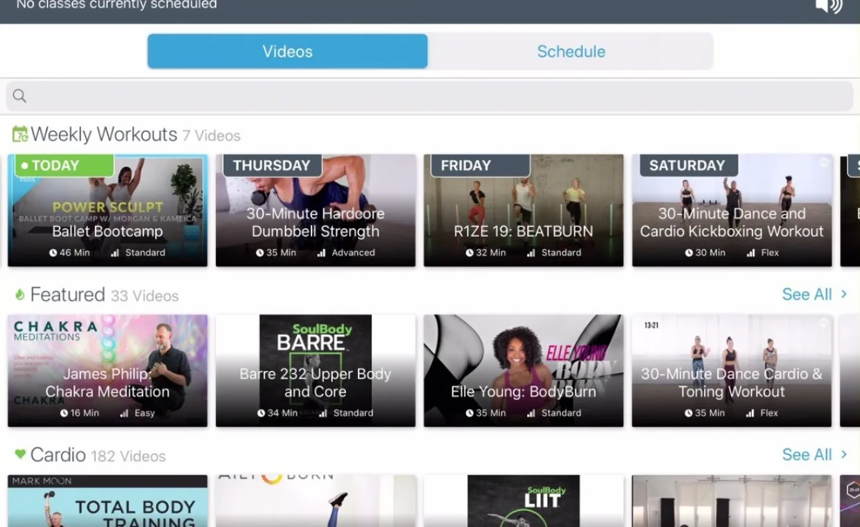 Screenshot of a fitness streaming platform showing weekly workout videos, featured classes, and cardio options. Categories include dance, strength, barre, and meditation, with thumbnails and class titles visible.